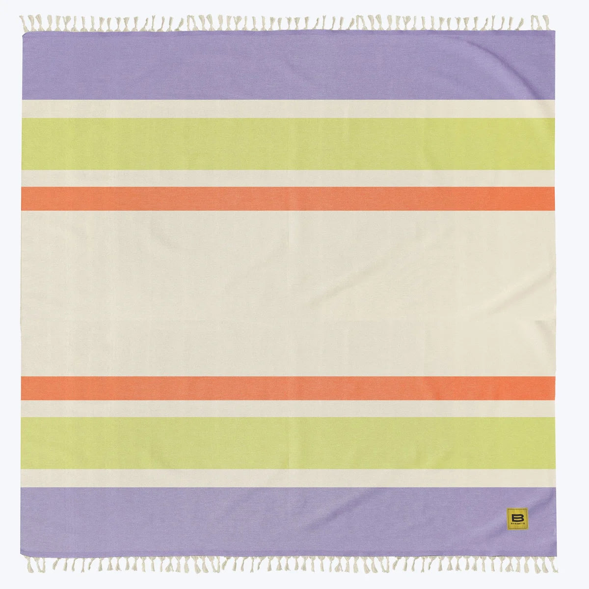 Big Beachy oversized blanket in cream with purple, yellow, and orange stripes, rolled and packaged with Big Blanket Co logo label