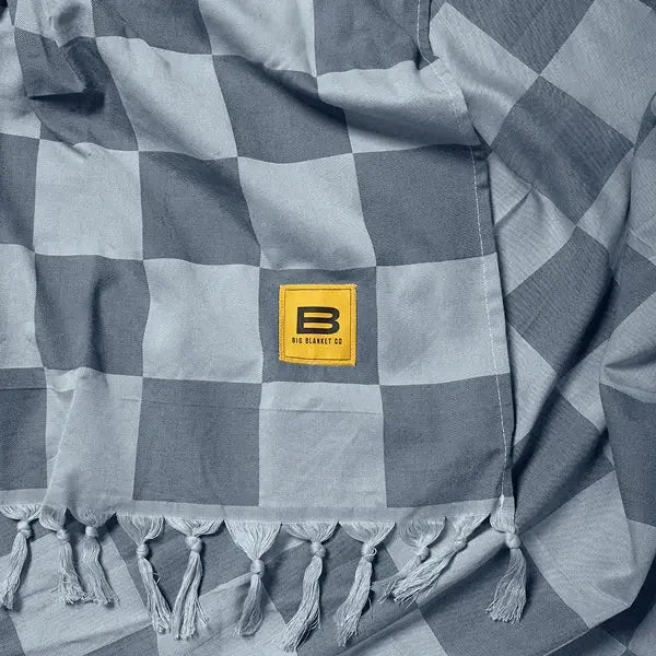 Charcoal and light gray checkered oversized blanket with fringe edges and yellow Big Blanket Co label