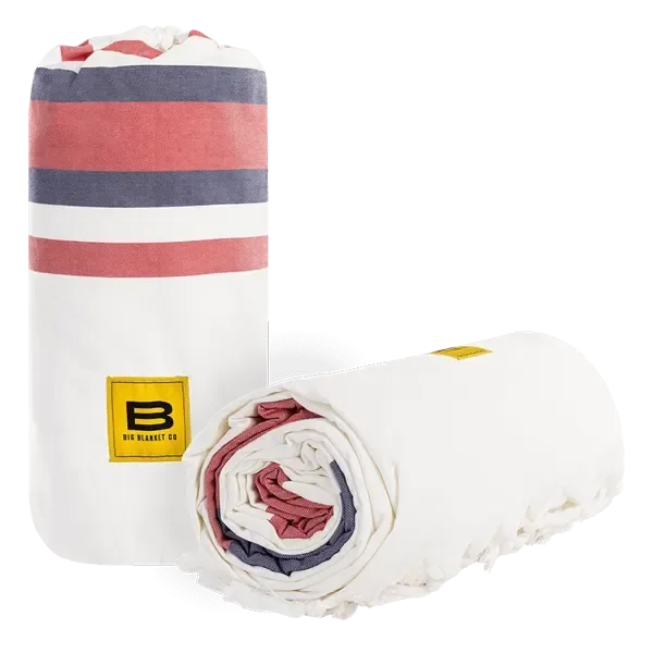 White oversized blanket with coral, navy, and white stripes, rolled and unrolled view, Big Blanket Co logo