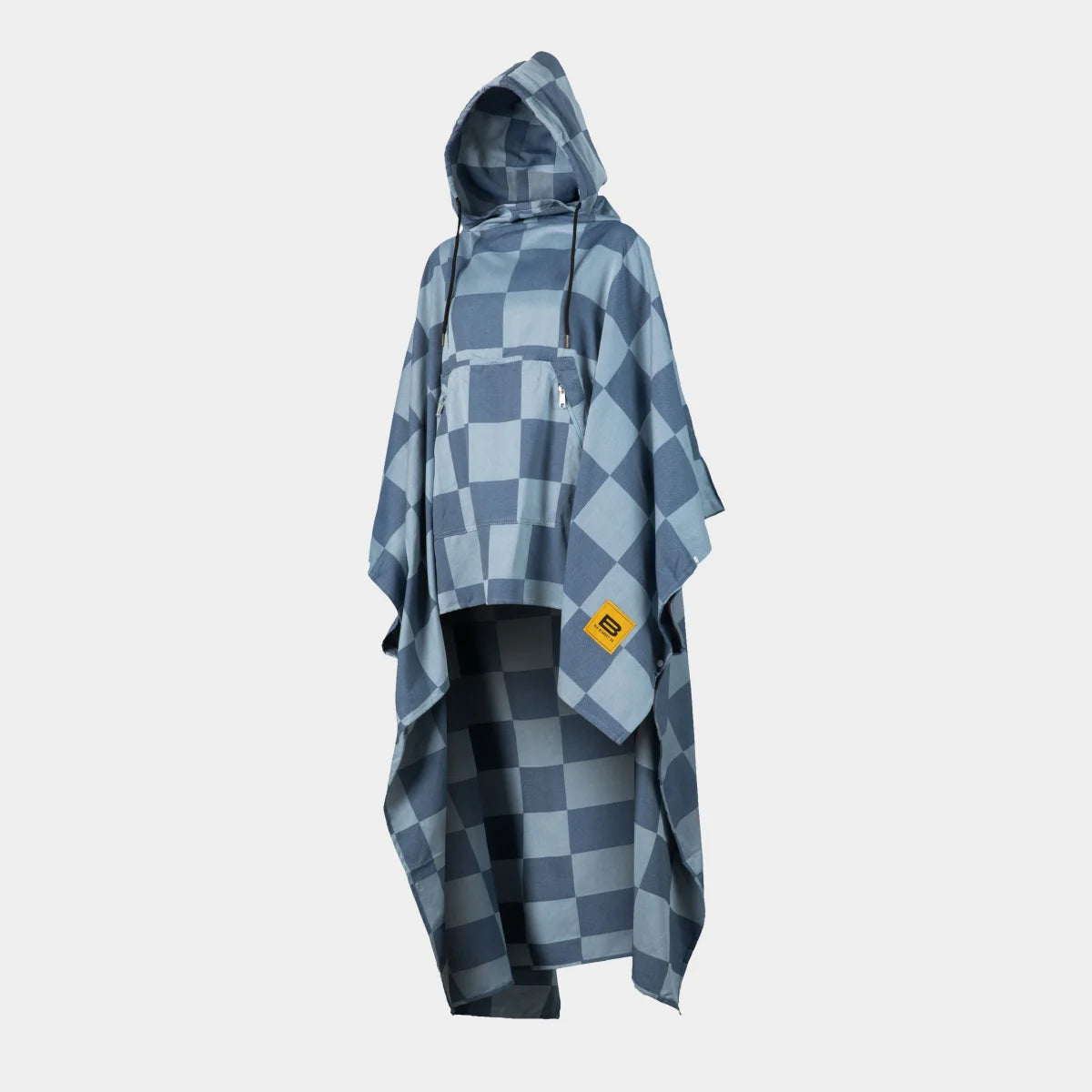 Blue checkered oversized poncho with hood and kangaroo pocket worn over black pants
