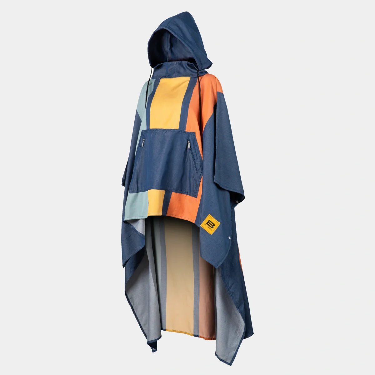 Navy, yellow, and coral striped oversized beach poncho with hood and front pocket worn over shoulders