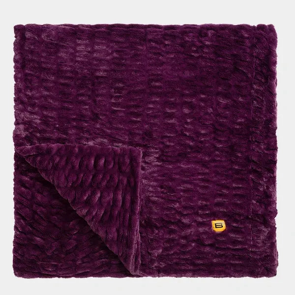 Plum Cloud Luxe oversized blanket with textured quilted fabric, corner folded to show plush texture