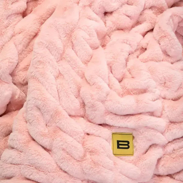 Plush rose pink oversized blanket with quilted texture and Big Blanket Co logo tag