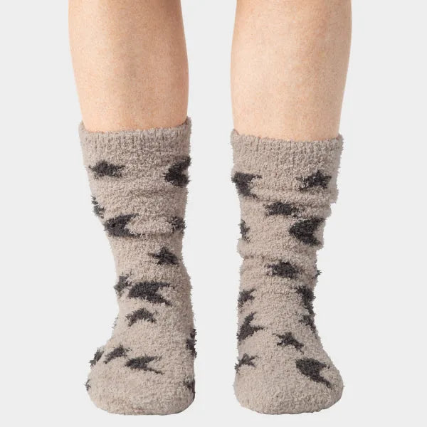 Beige cozy crew socks with charcoal star pattern, displayed on legs against white background