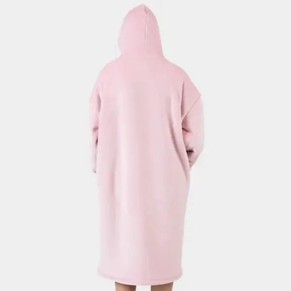 Blush pink oversized hoodie blanket worn as wearable garment, rear view showing hood and long relaxed fit