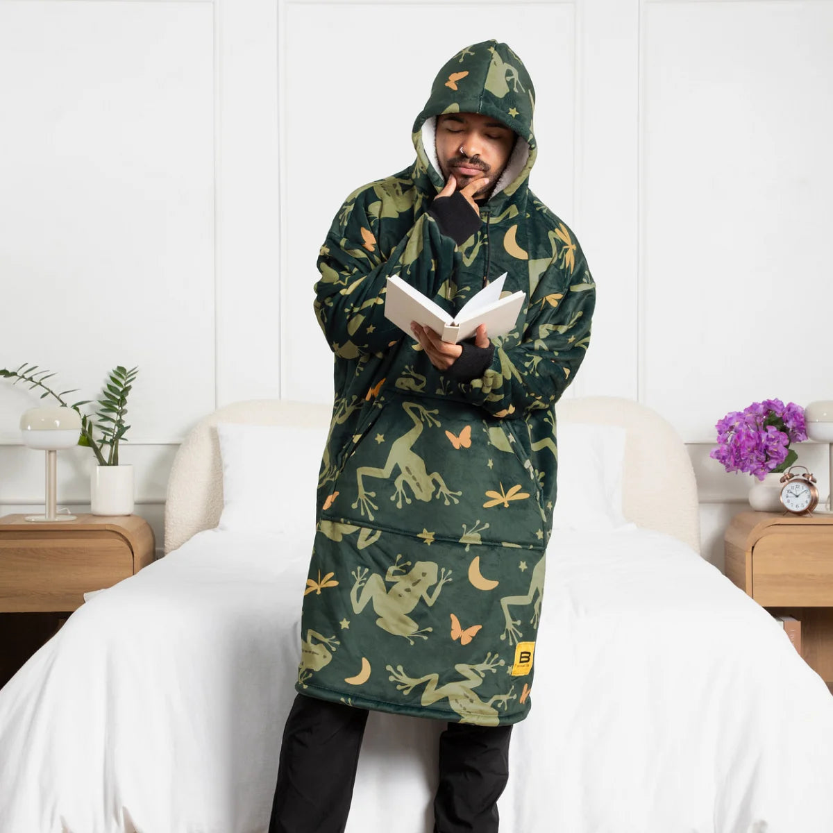 Person wearing the Dreamy Frogs Hideout Hoodie™ and holding a bowl of popcorn