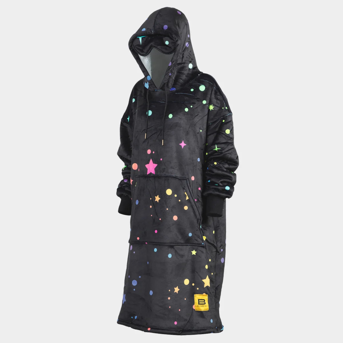 Hideout Hoodie™ wearable blanket in Electric Sky, side view with the built-in eye mask on the hood — charcoal ground scattered with multicolour stars, sparkles and dots in pink, teal, yellow, blue and green