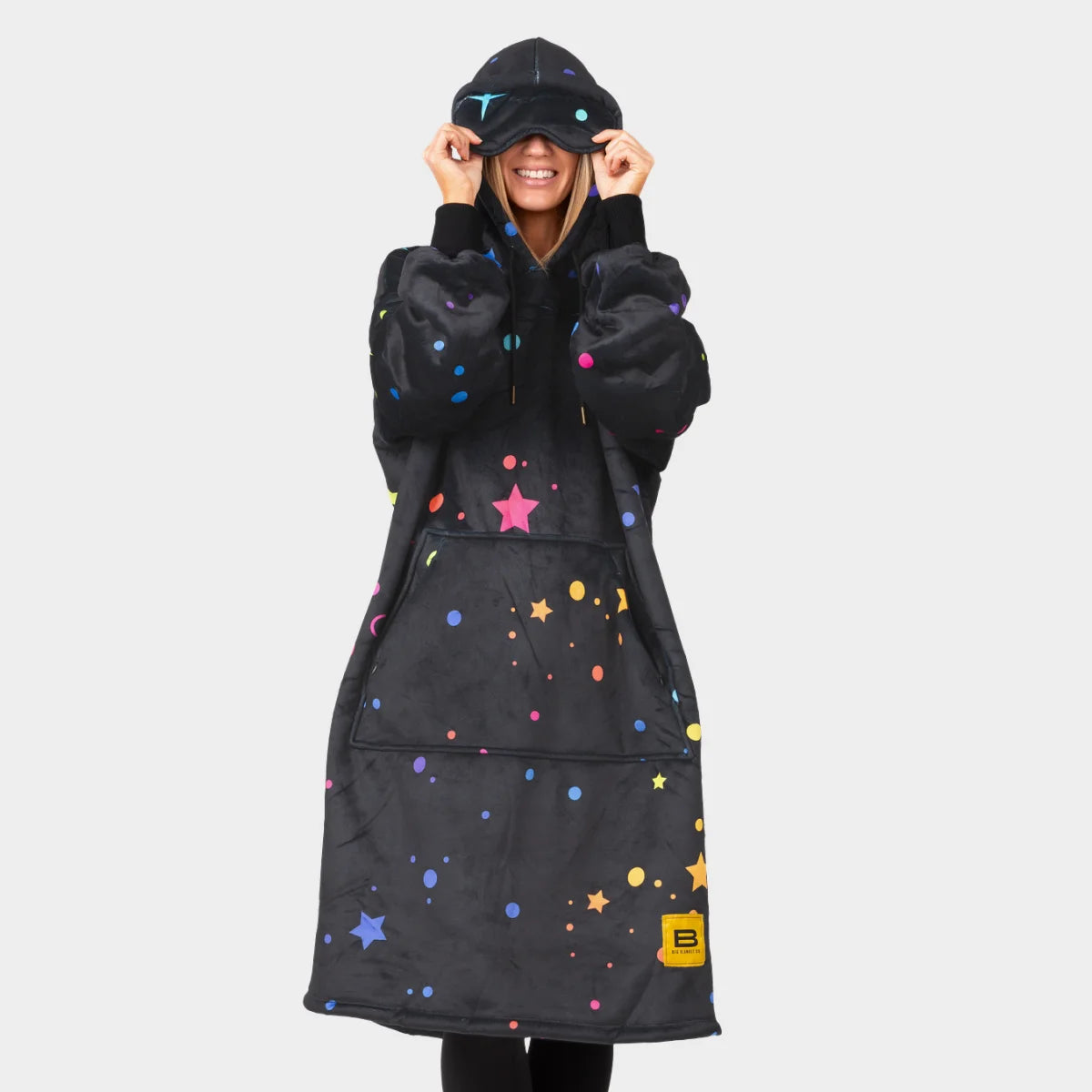 Person pulling the built-in eye mask of the Electric Sky Hideout Hoodie™ down over their eyes