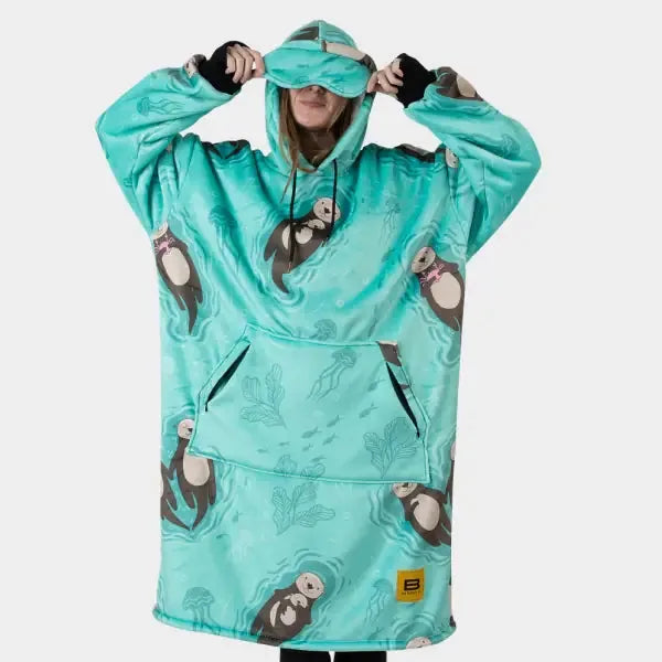 Turquoise Hideout Hoodie with otter print, model wearing oversized blanket with hood and kangaroo pocket