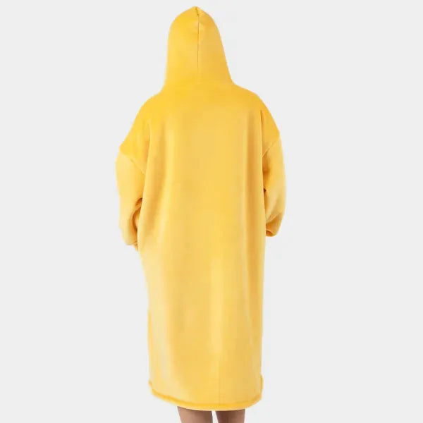 Bright yellow oversized hoodie blanket worn as wearable garment, back view