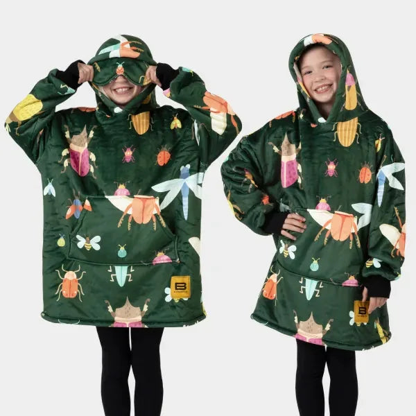 Kids wearing forest green Hideout Hoodie blankets with colorful bug and insect print, oversized fit with hood and kangaroo pocket