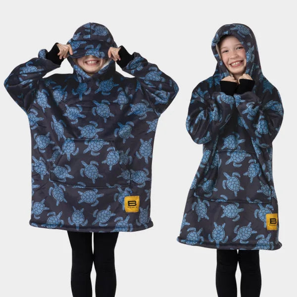 Navy oversized hoodie blanket with blue turtle pattern, drawstring hood, and kangaroo pocket on two children