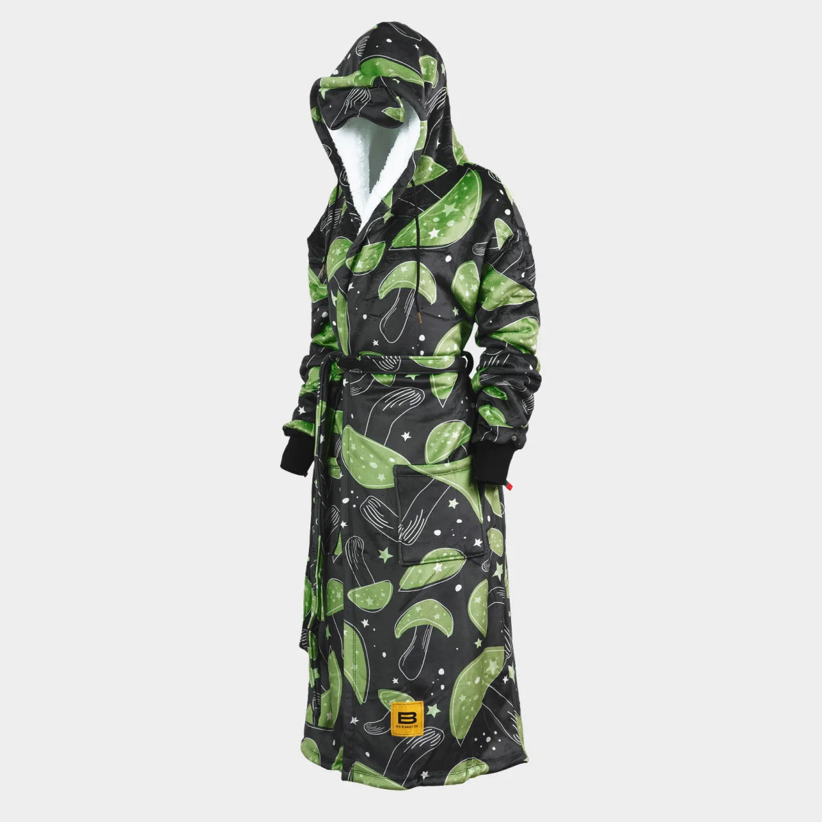 Hideout Robe™ in Mystic Mushrooms, side view showing the sherpa-lined hood, tie belt and patch pockets — near-black charcoal ground scattered with large green mushroom caps, cream stars and speckles
