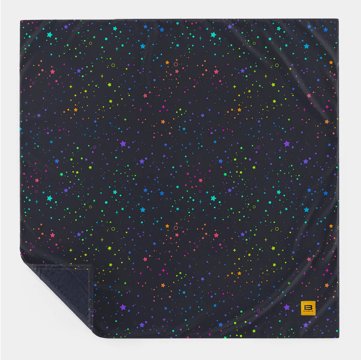 Electric Sky Original Stretch™ blanket laid flat with one corner turned back, showing the full repeating star and dot print
