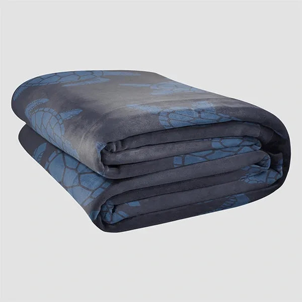 Charcoal and blue oversized stretch blanket folded, showing geometric pattern design on edges