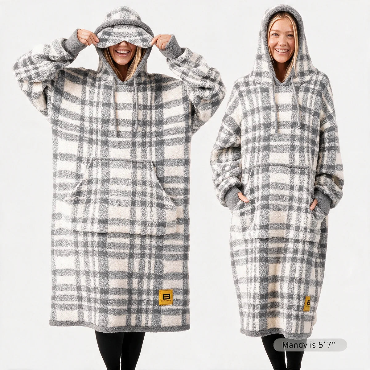 Premier Plush™ Hoodie wearable blanket in Grey Plaid, front and back on two models — a warm cream ground in a soft neutral grey plaid, with grey edge binding, cuffs and trim