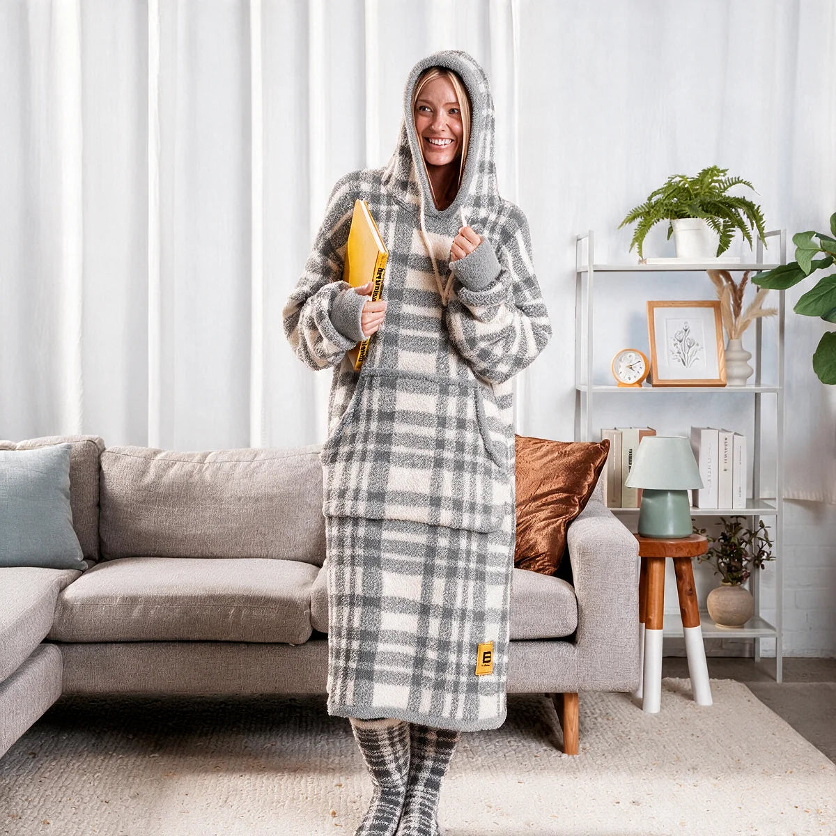 Person standing in a bedroom wearing the Grey Plaid Premier Plush™ Hoodie with the hood up