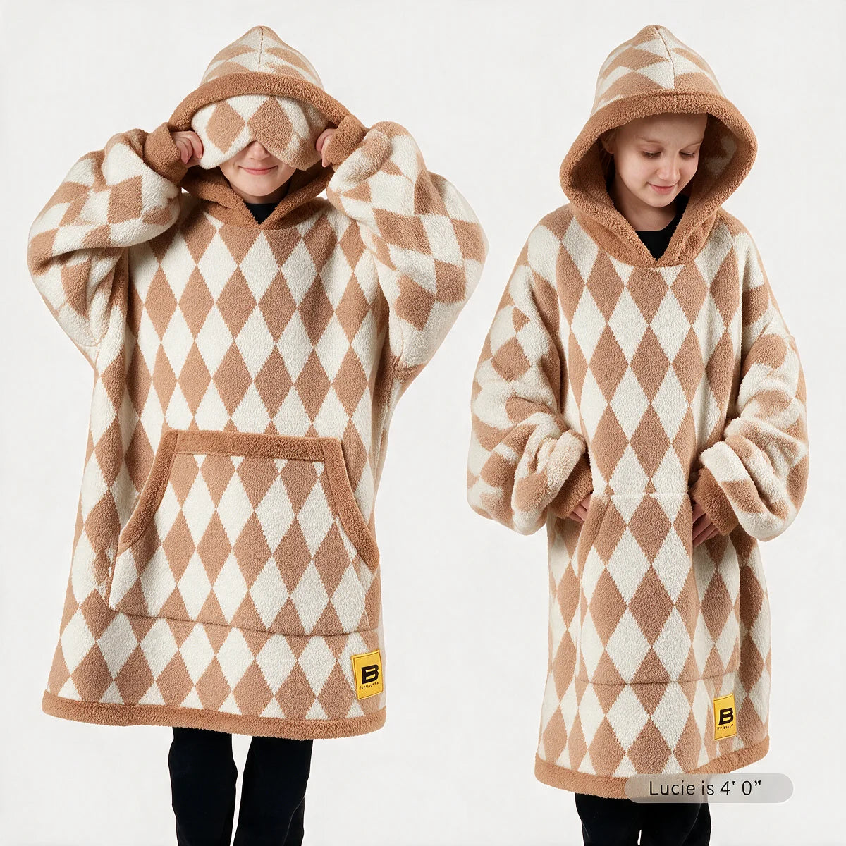 Premier Plush™ Hoodie Kids wearable blanket in Dusty Diamond, front and back on two child models — a buttercream cream ground in a harlequin diamond lattice of warm camel tan, with tan edge binding, cuffs and trim