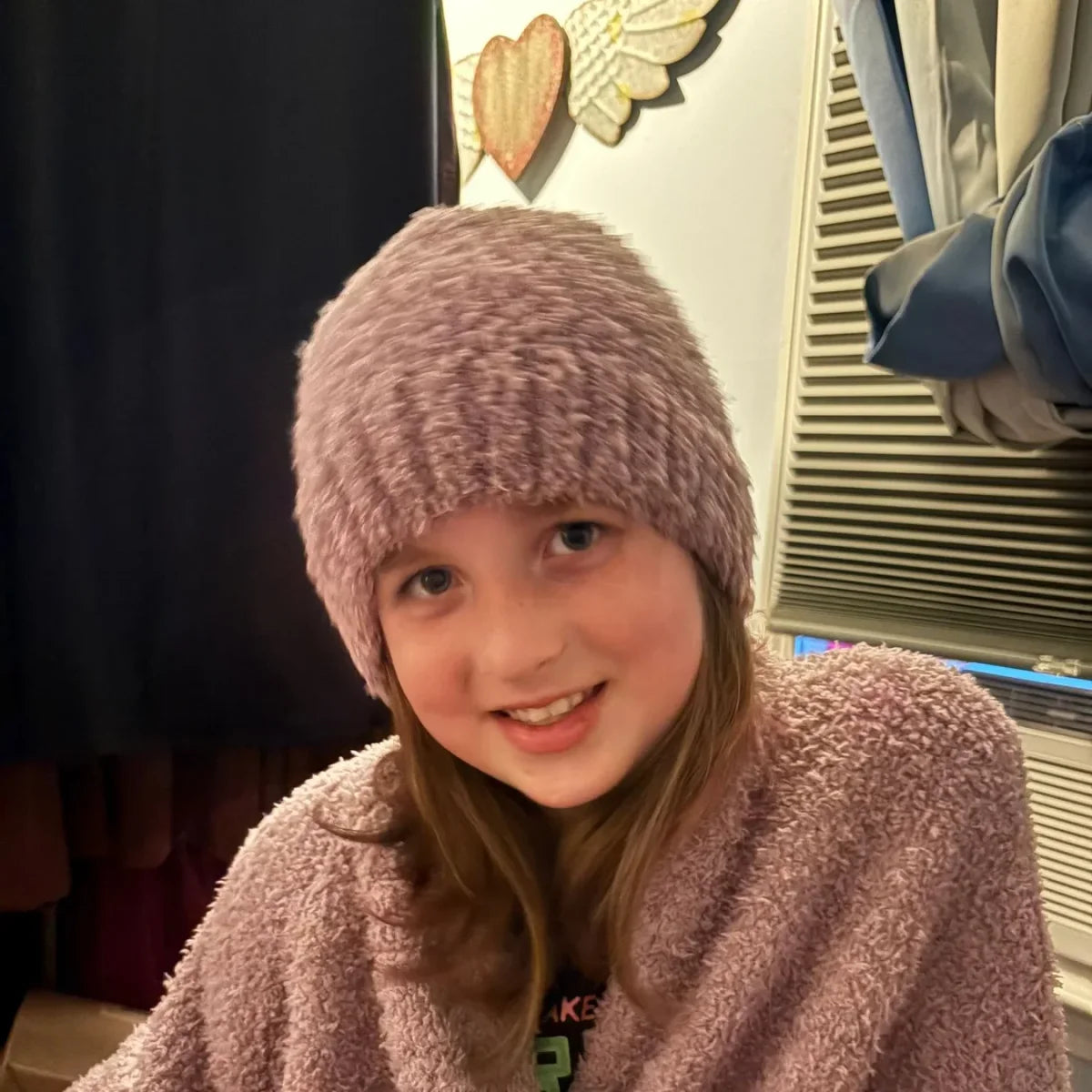 Child wearing mauve Premier Plush oversized blanket wrapped around shoulders with matching beanie