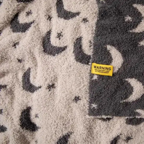 Cream and charcoal leopard print oversized plush blanket with soft textured surface