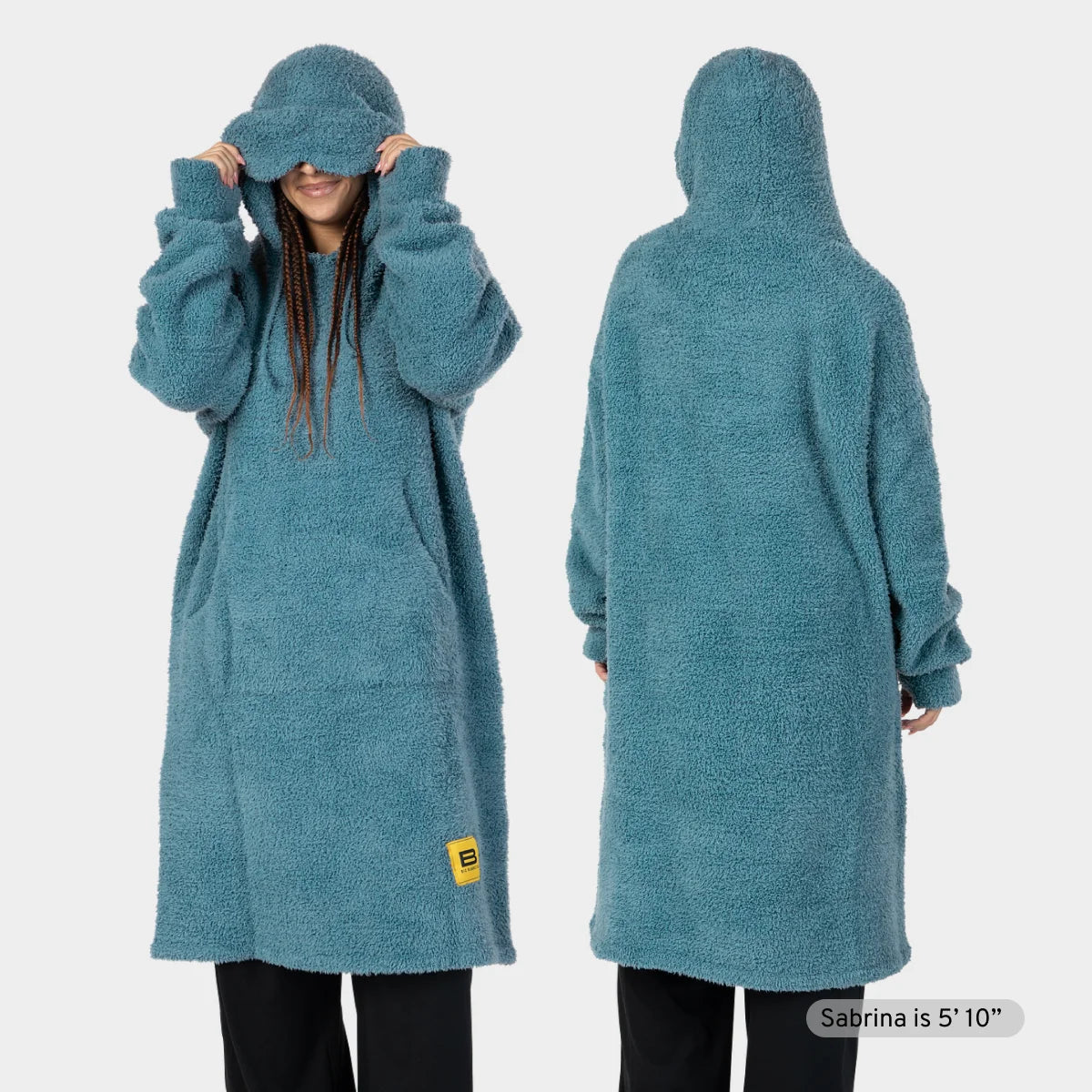 Girl wearing oversized teal fluffy hoodie blanket with hood pulled up, showing front and back views
