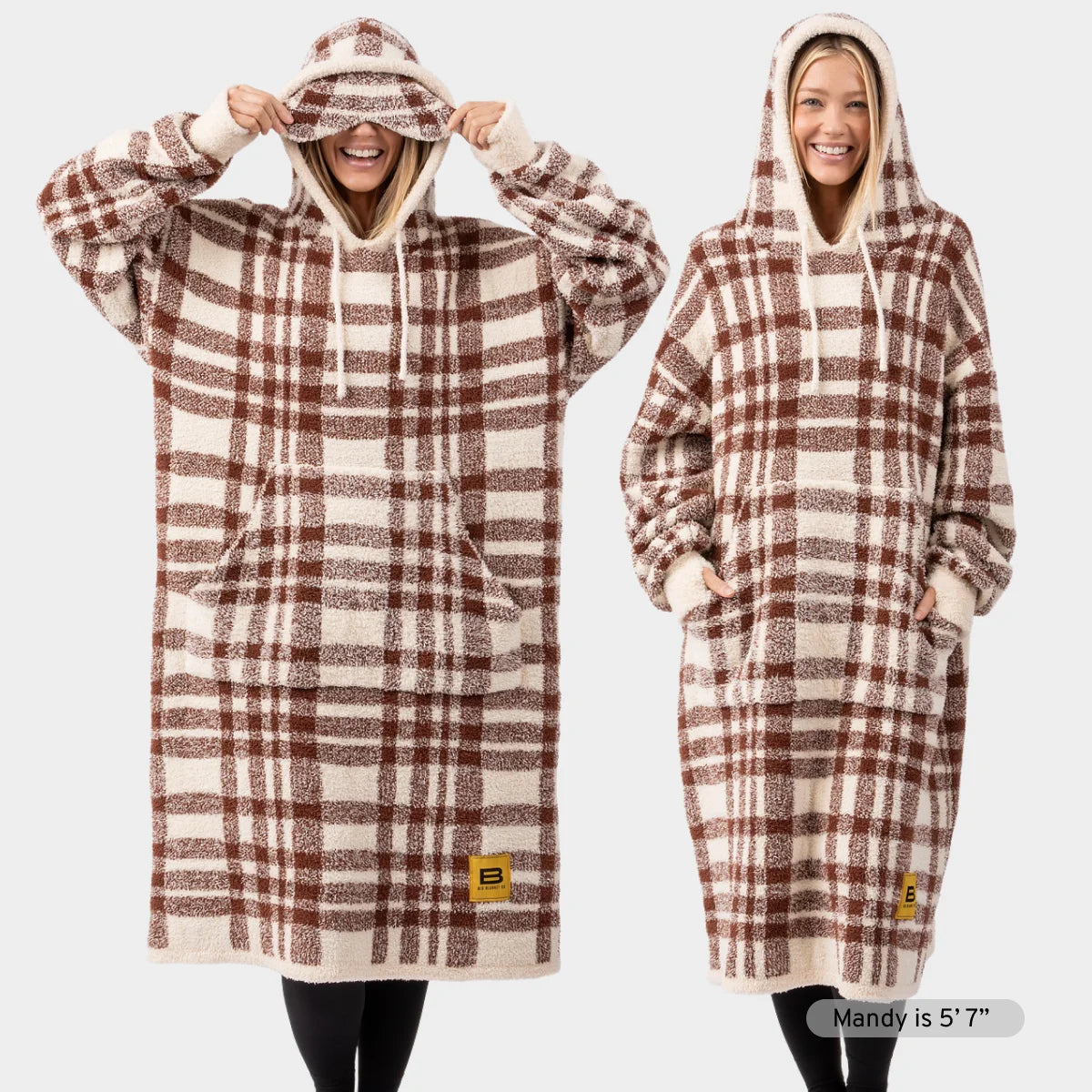 Brown and cream plaid oversized hoodie blanket with kangaroo pocket, shown on two models wearing the wearable blanket