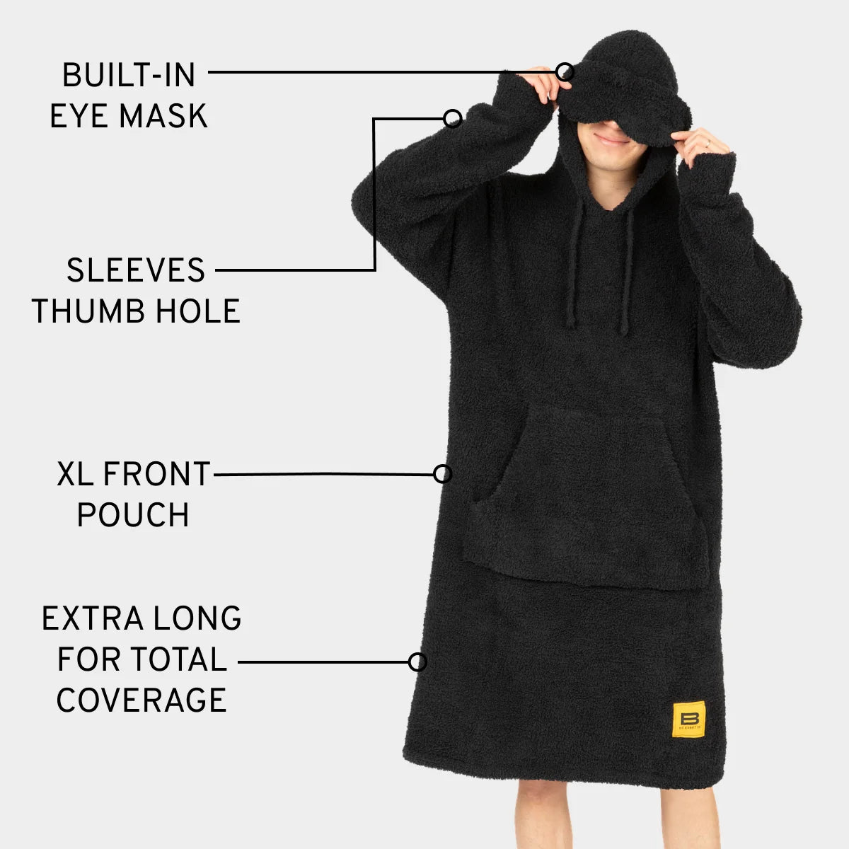 Black oversized hoodie blanket with built-in eye mask, thumb hole sleeves, XL front pouch, and extra long length for total coverage