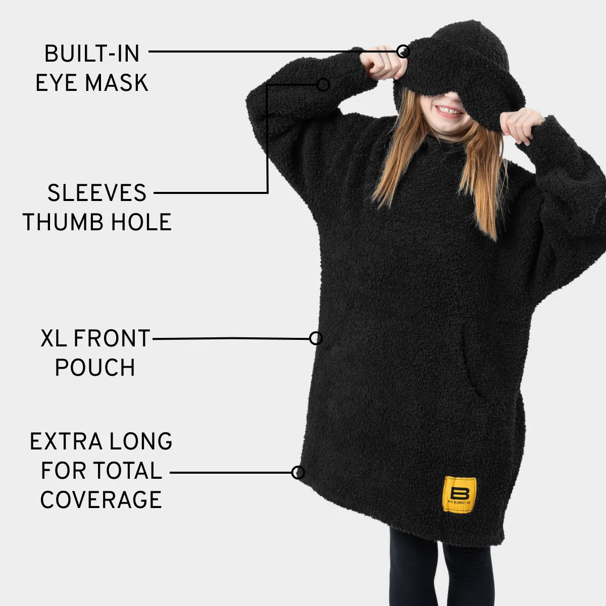 Black oversized hoodie blanket with built-in eye mask, thumb hole sleeves, XL front pouch, and extra-long length for total coverage