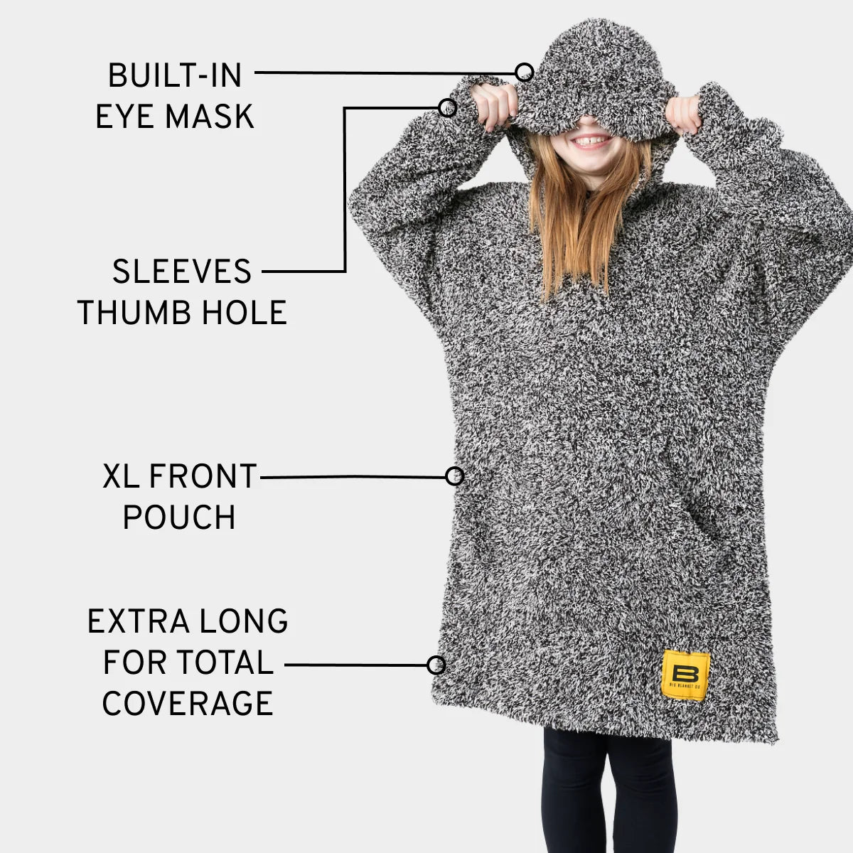 Man wearing charcoal heather oversized blanket hoodie with built-in eye mask, sleeve thumb holes, XL front pouch, and extra-long coverage