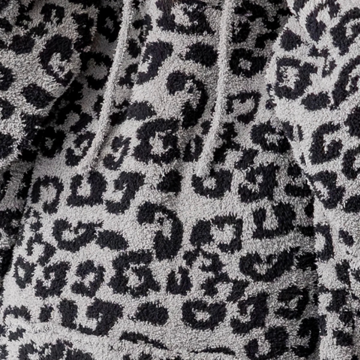 Black and white leopard print oversized blanket with soft plush texture and hood detail