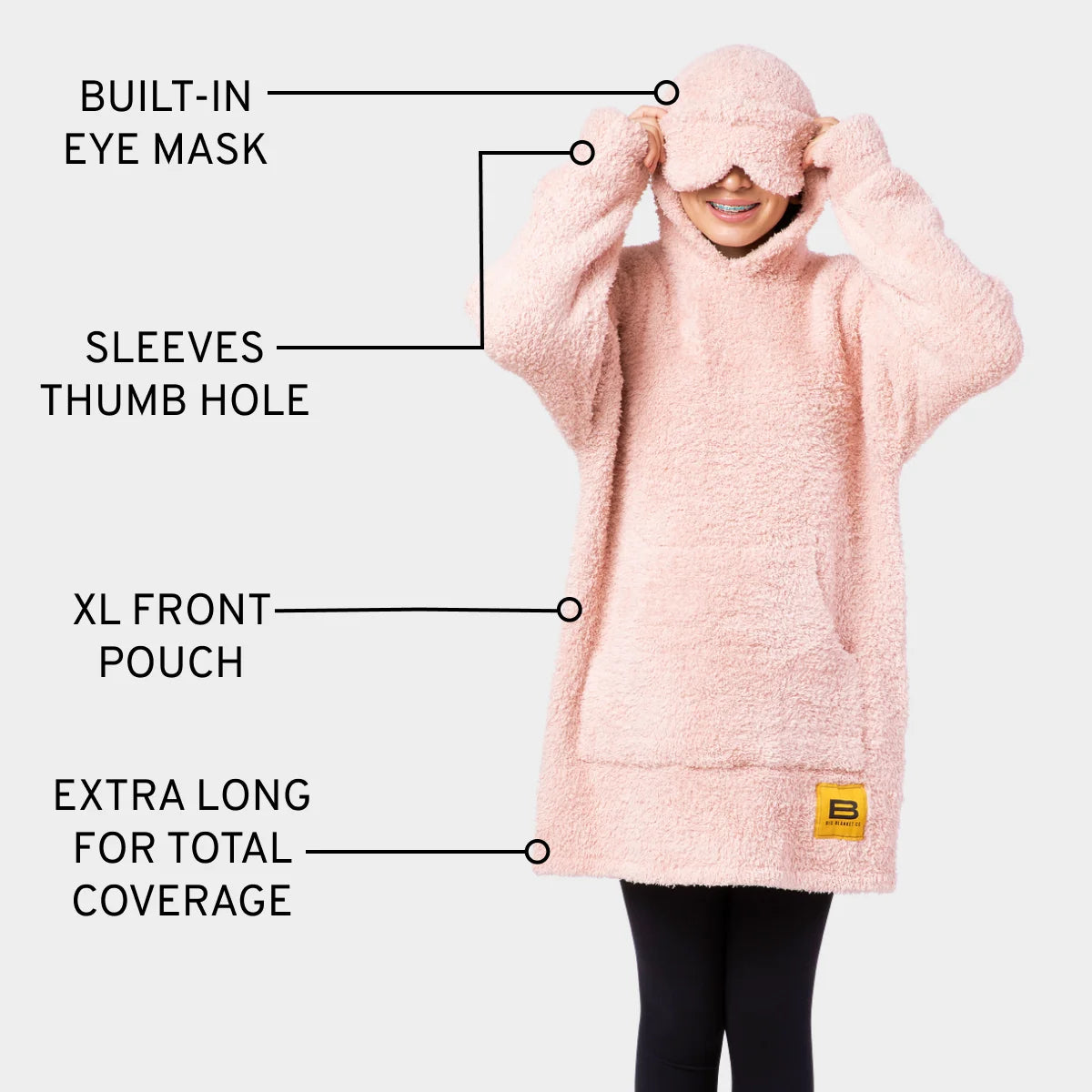 Pink oversized hoodie blanket with built-in eye mask, thumb holes, and XL front pouch for kids