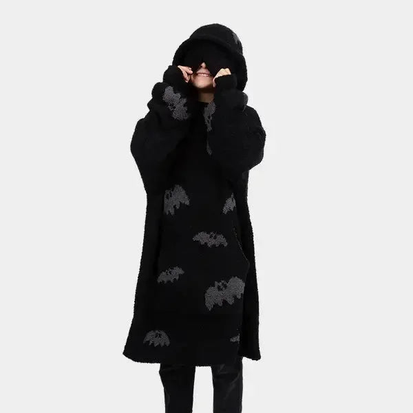 Black oversized hoodie blanket with gray bat pattern, worn by child with hood pulled up