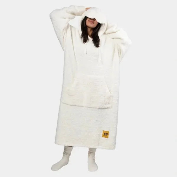Person wearing cream Premier Plush hoodie blanket with oversized hood and kangaroo pocket