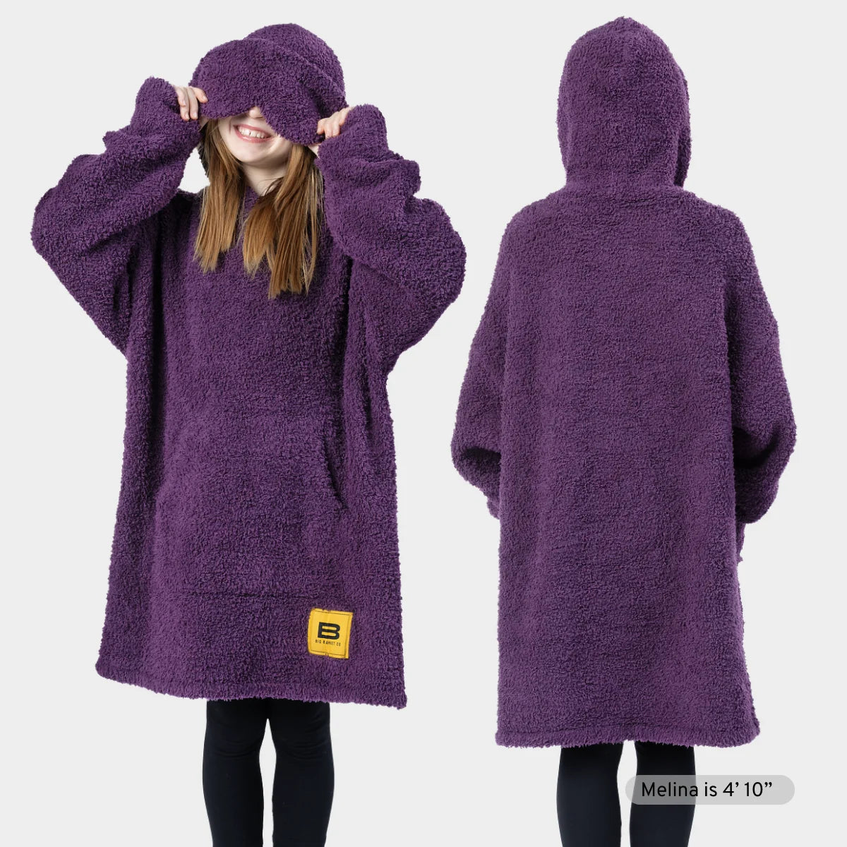 Deep purple oversized hoodie blanket with front pocket, shown on two models in different poses