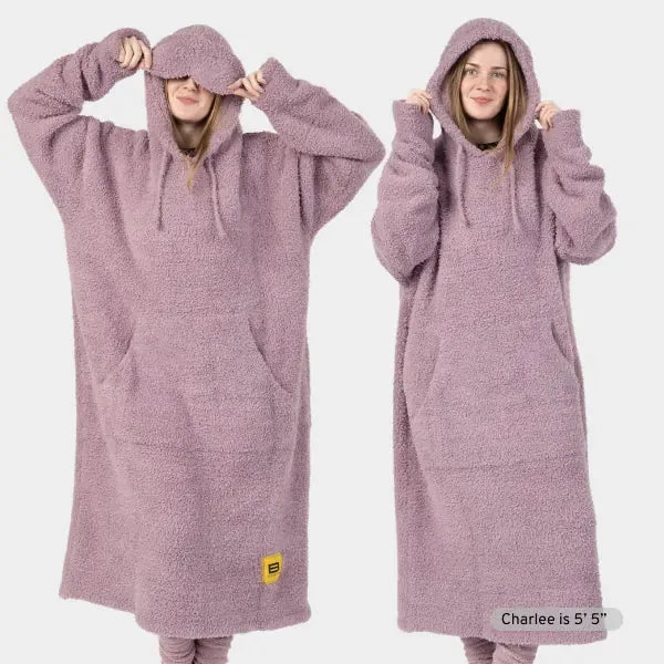 Mauve oversized hoodie blanket worn by two models showing front and side views, with spacious hood and kangaroo pocket