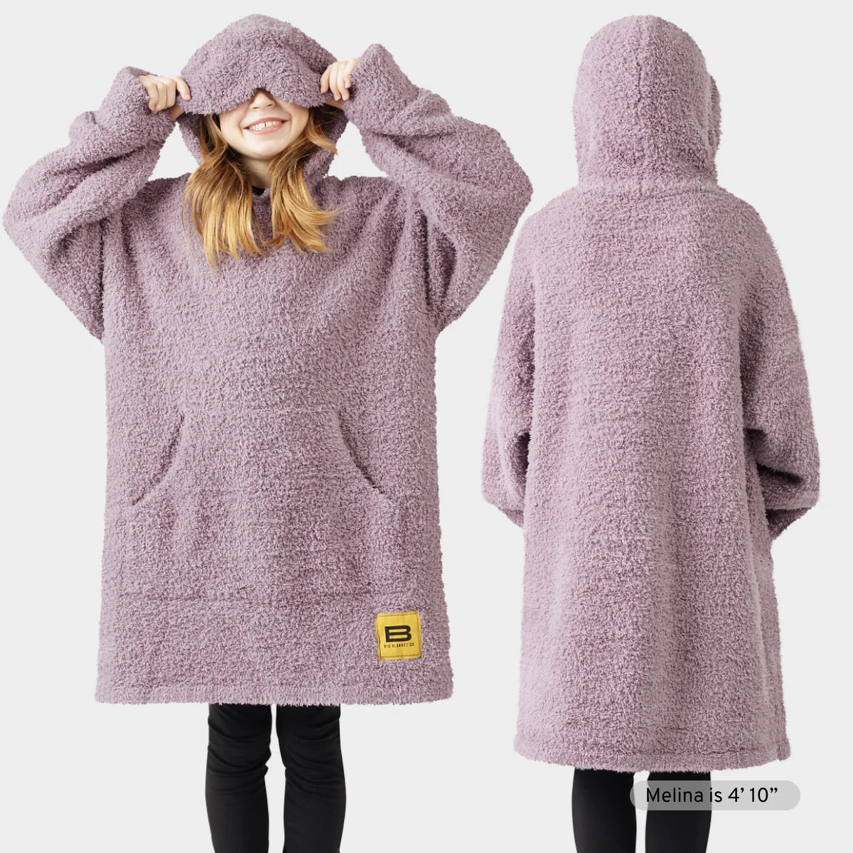 Mauve oversized hoodie blanket with built-in eye mask, thumb holes in sleeves, XL front pouch, modeled by child