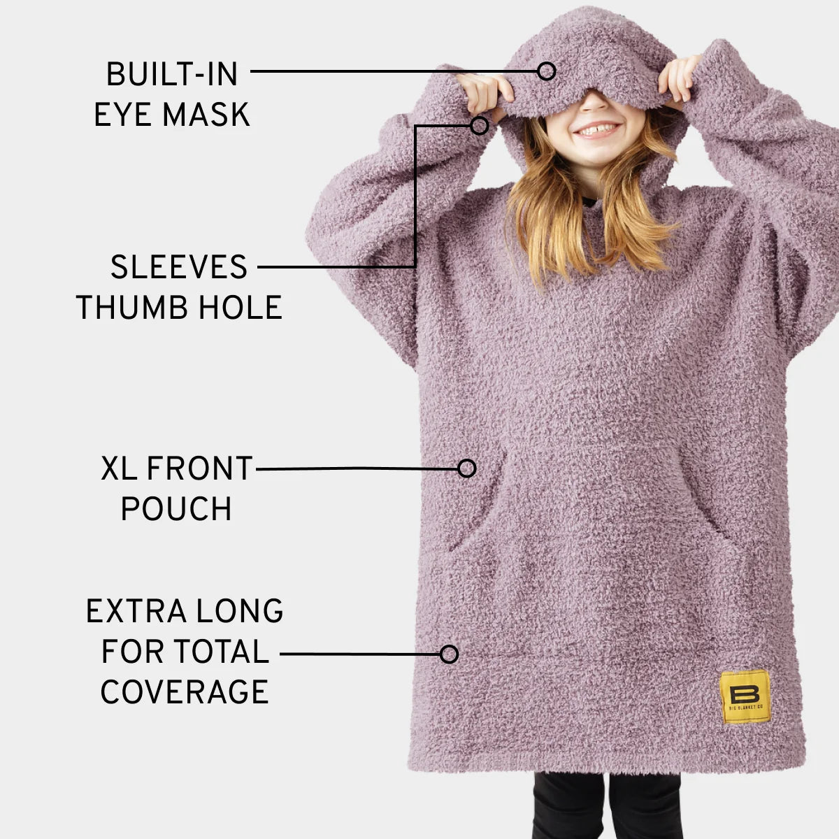 Soft textured plush fabric in dusty mauve-pink, showing cozy woven material detail of kids oversized hoodie blanket