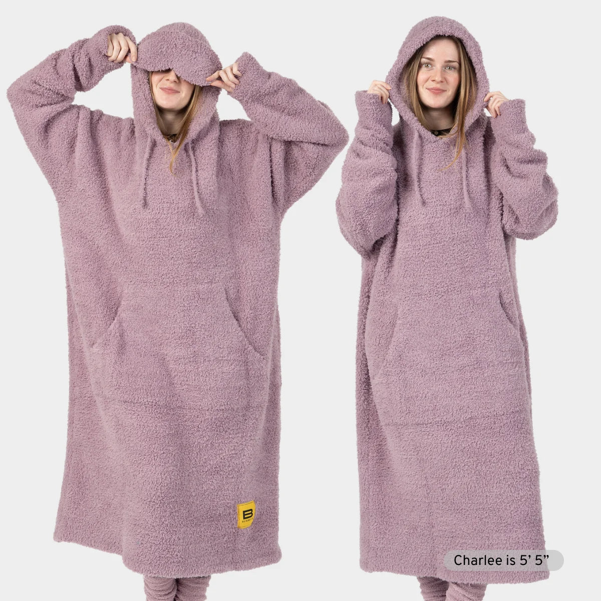 Mauve oversized hoodie blanket with drawstring hood shown on two models demonstrating relaxed fit and length