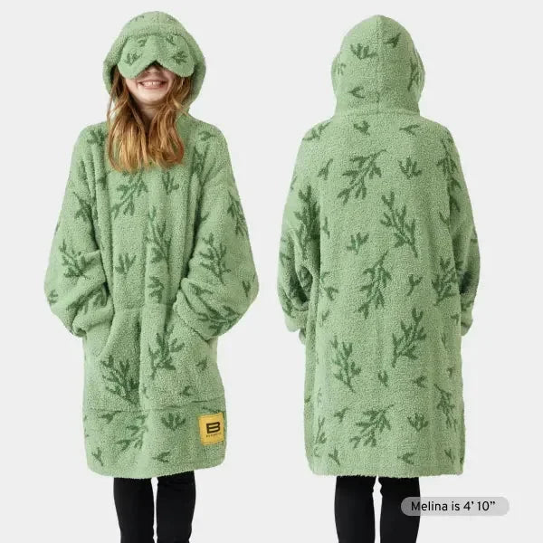 Sage green kids oversized hoodie blanket with evergreen forest pattern, front and back view, featuring attached hood and kangaroo pocket