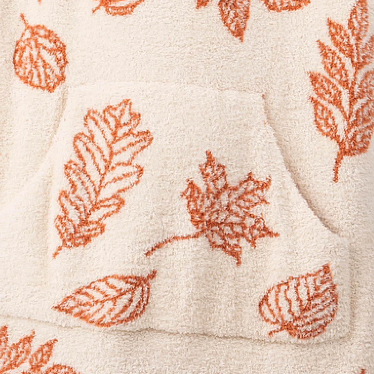 Cream oversized blanket with rust orange falling leaves pattern, Premier Plush texture visible on corner fold