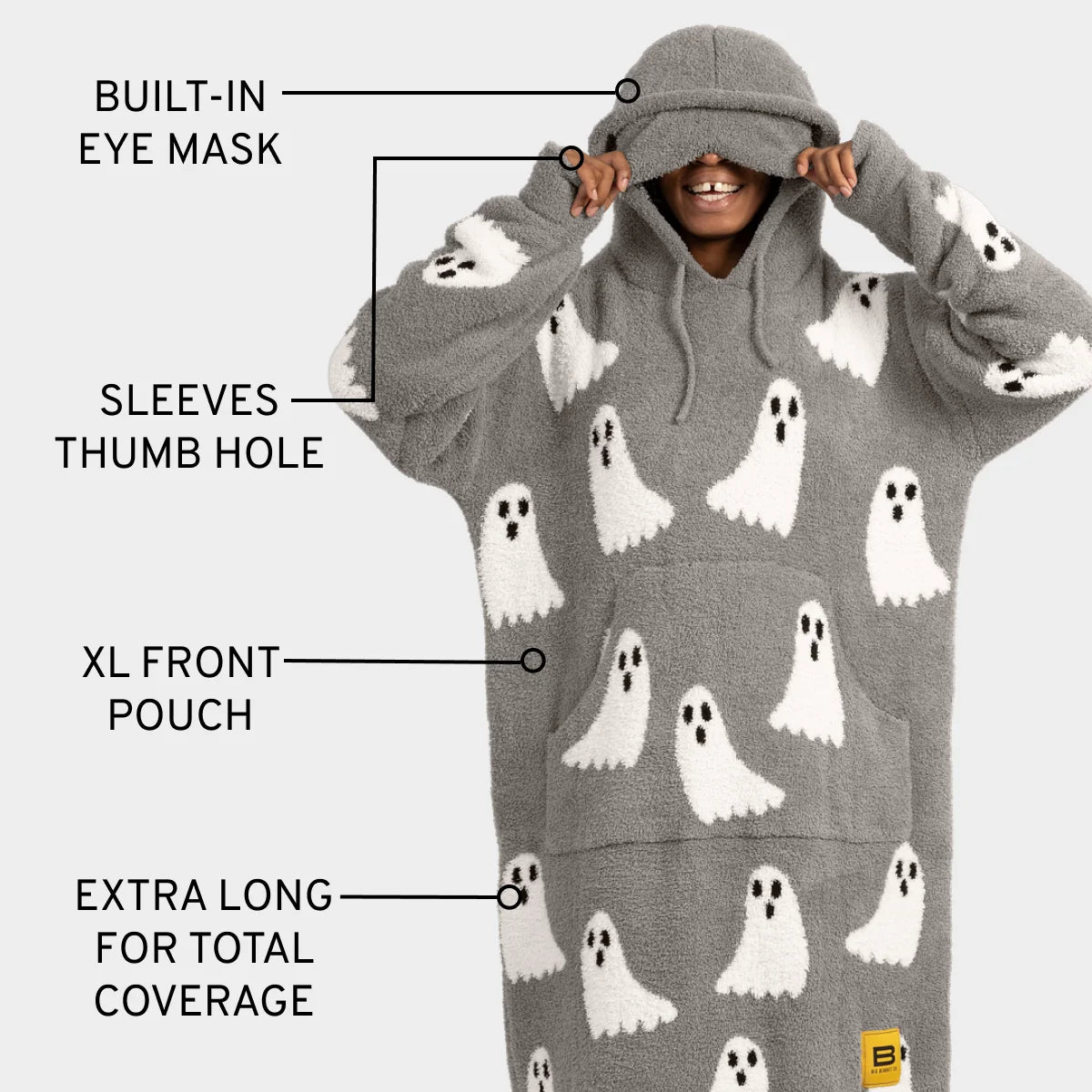 Gray oversized hoodie blanket with white ghost pattern, built-in eye mask, thumb hole sleeves, XL front pouch, extra long coverage