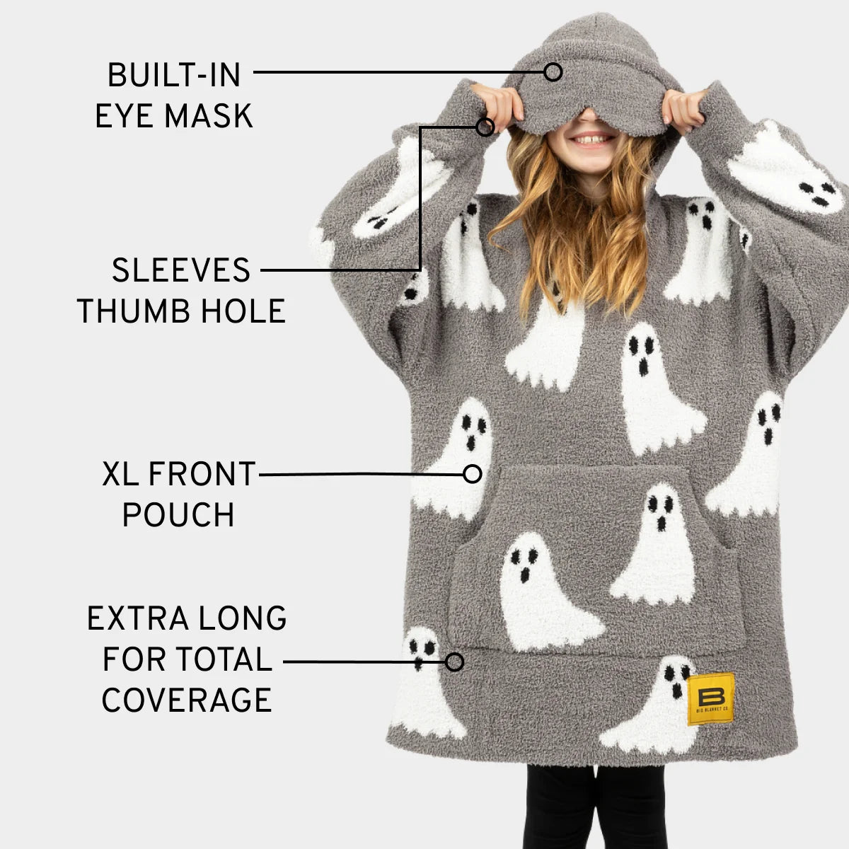 Gray oversized hoodie blanket with white ghost pattern, built-in eye mask, thumb holes, front pouch, extra long length for kids