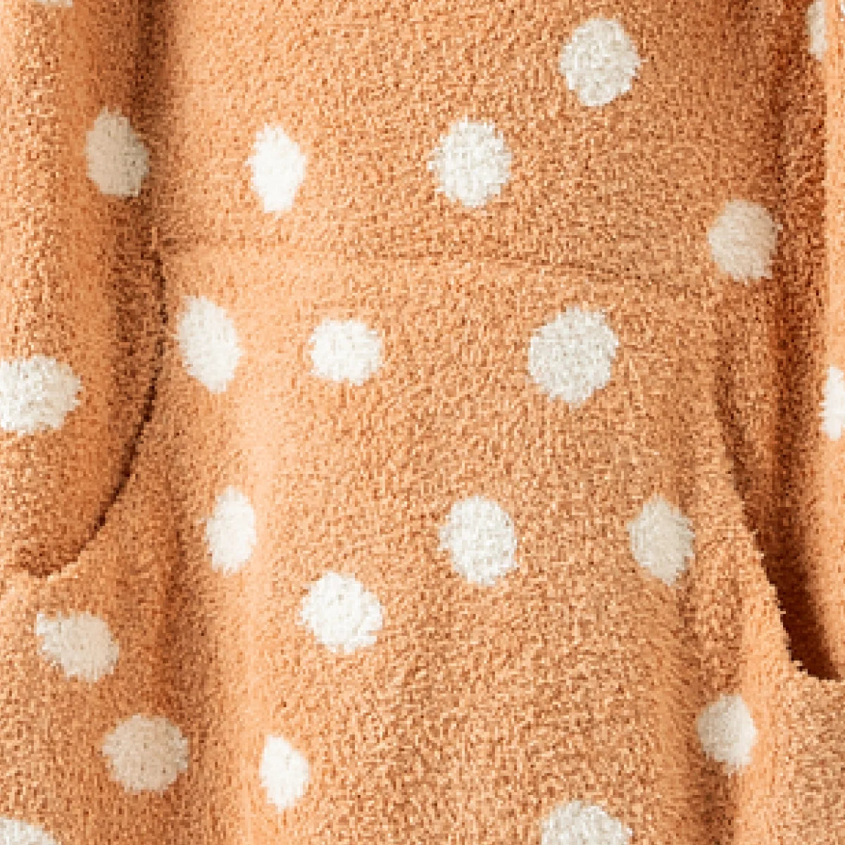 Ginger oversized hoodie blanket with white polka dot pattern, textured plush fabric