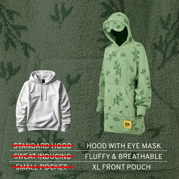 Sage green oversized hoodie with fern print and eye mask hood, displayed against textured background next to white standard hoodie for size comparison