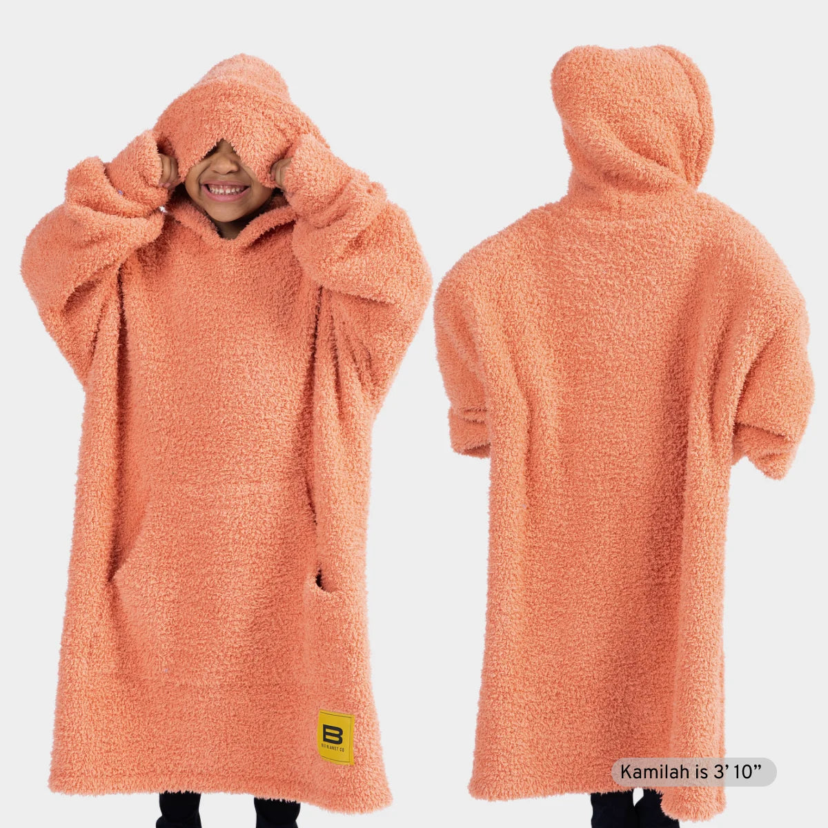 Peach oversized hoodie blanket with hood on child, front and back view, shown with matching socks