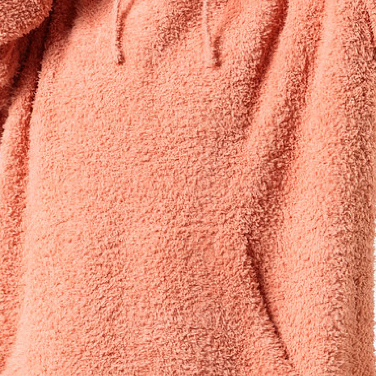 Coral-peach textured oversized blanket fabric with soft plush pile and draping folds