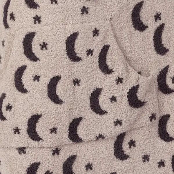 Cream oversized blanket with black moon and star pattern, soft plush texture visible