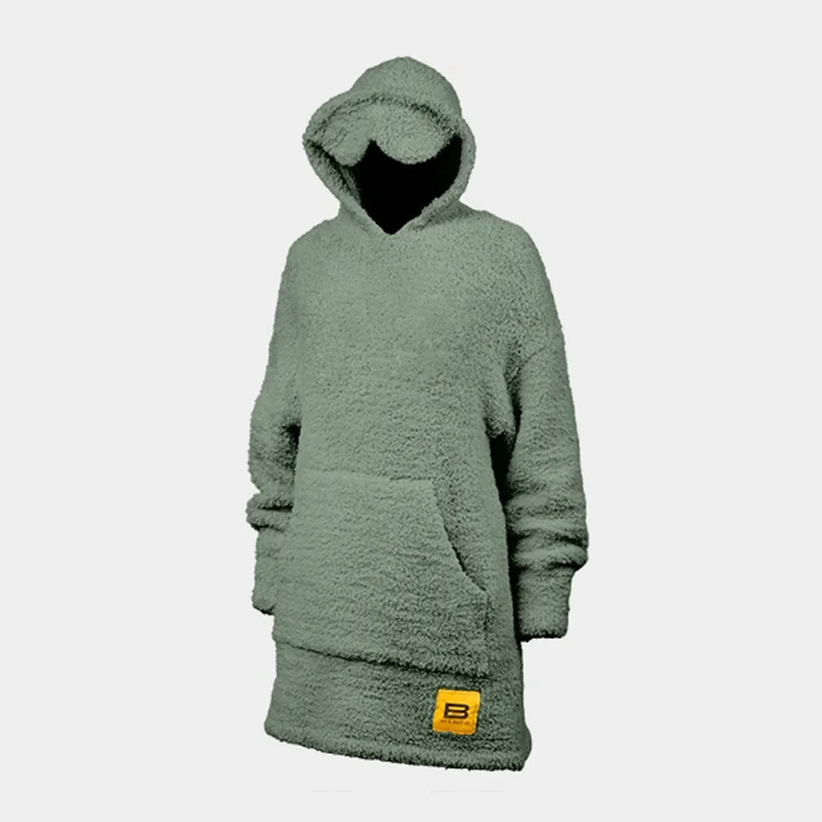 Woman wrapped in moss green oversized hoodie blanket with textured fabric and kangaroo pocket