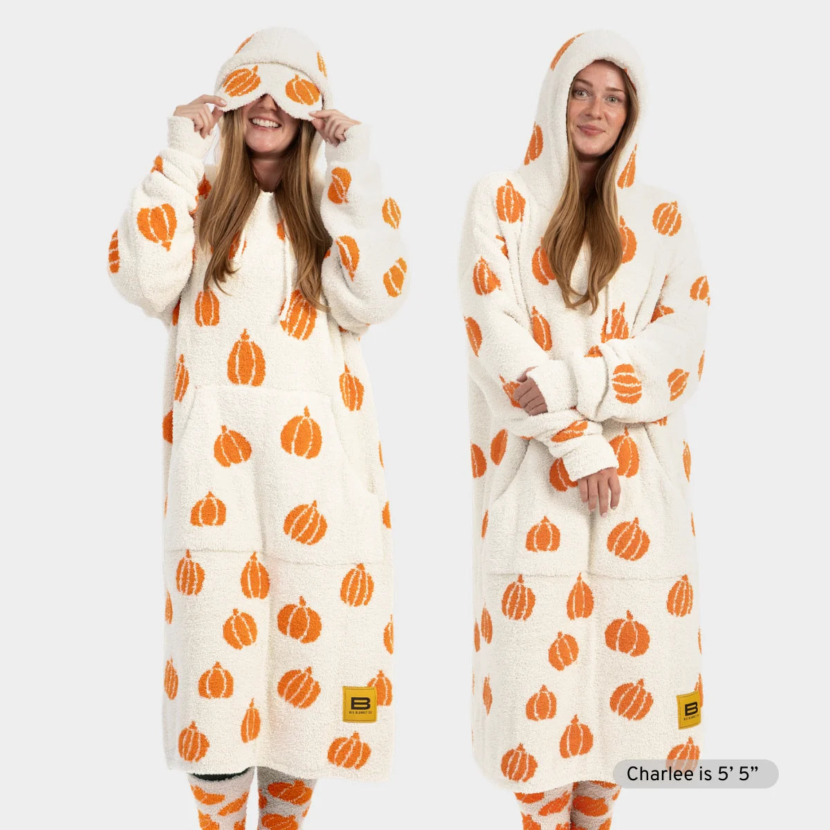 Cream oversized hoodie blanket with orange pumpkin print, worn by woman showing front and side views with matching eye mask