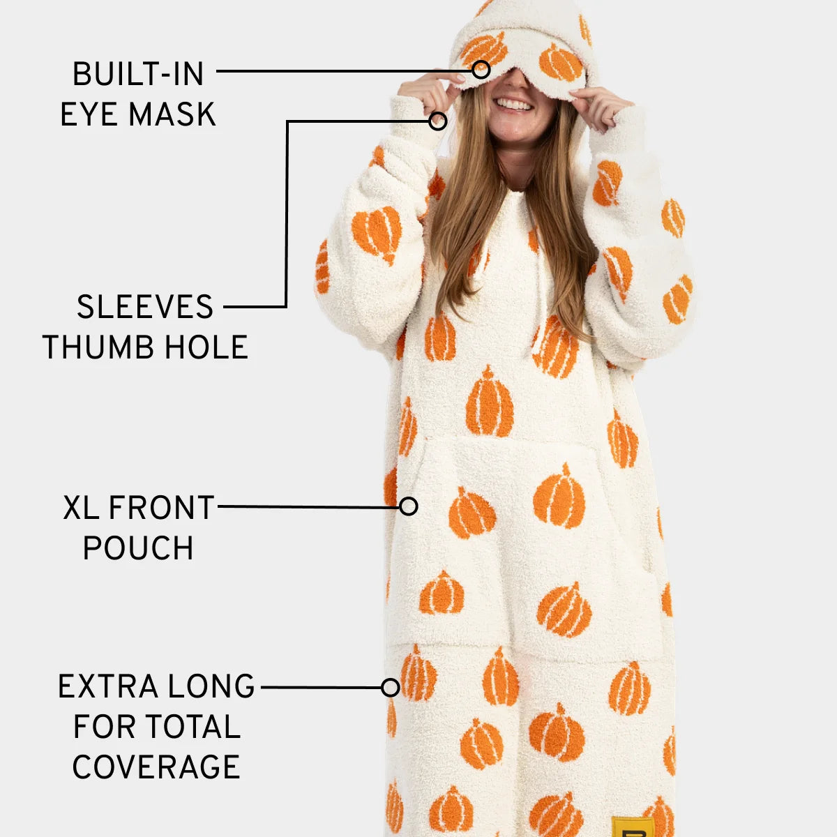 Cream oversized hoodie blanket with orange pumpkin print, built-in eye mask, thumb hole sleeves, XL front pouch, extra long coverage